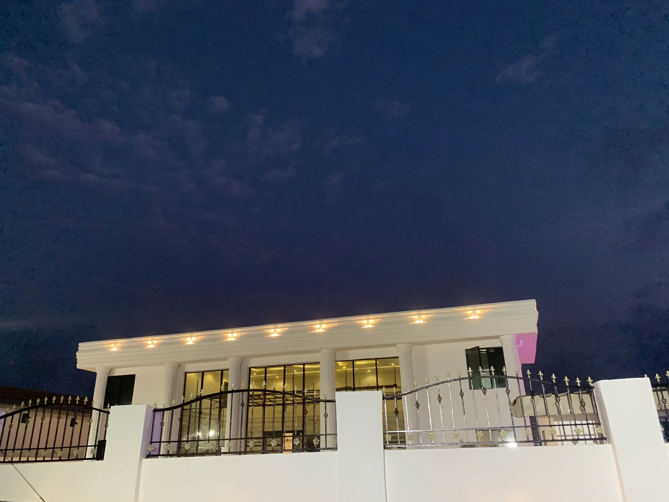 The front of the hall at night, the cornice lights on