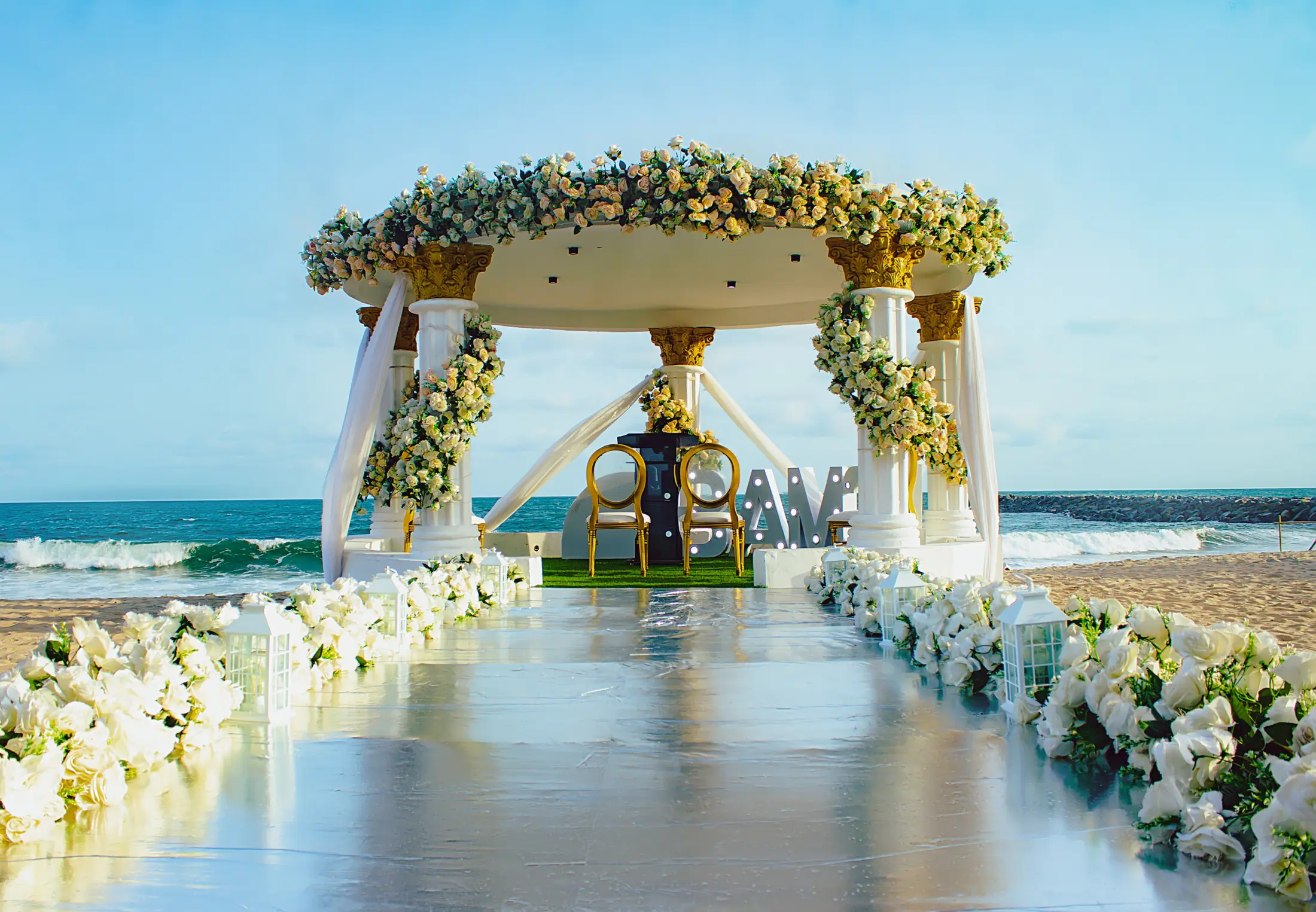 A circle of flowers framing the gazebo by the sea