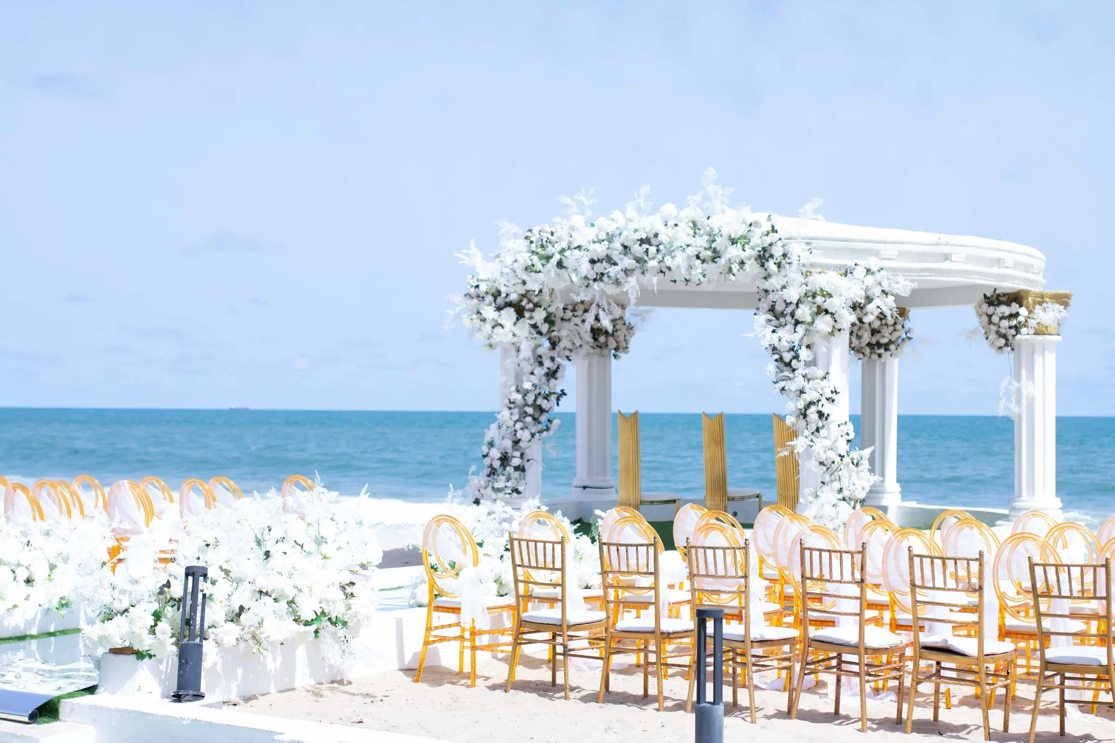 The dressed gazebo and rows of gold chairs along the shoreline