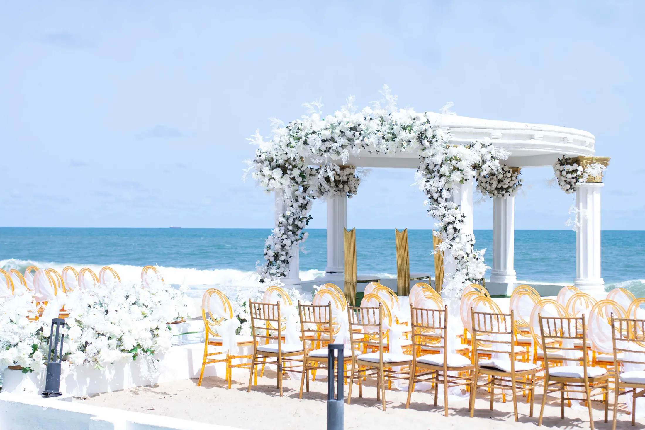 The flower-dressed gazebo from the side, the sea beyond