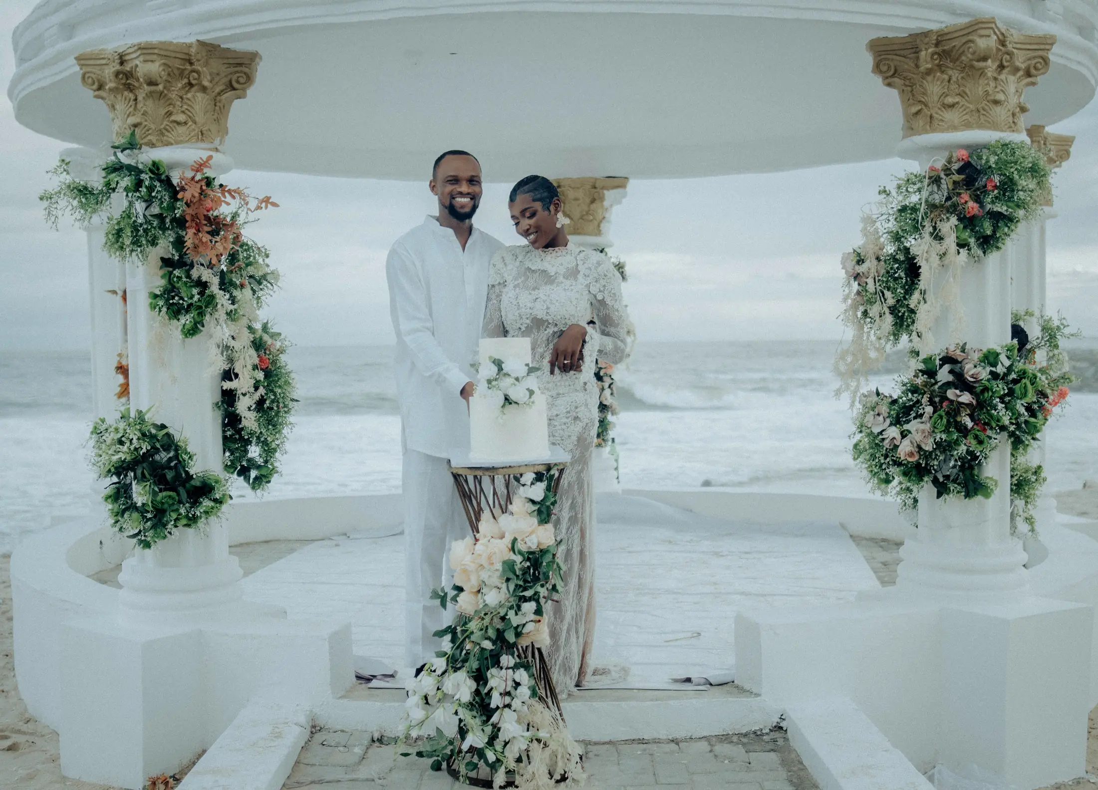 A couple framed by the gazebo's flowered columns