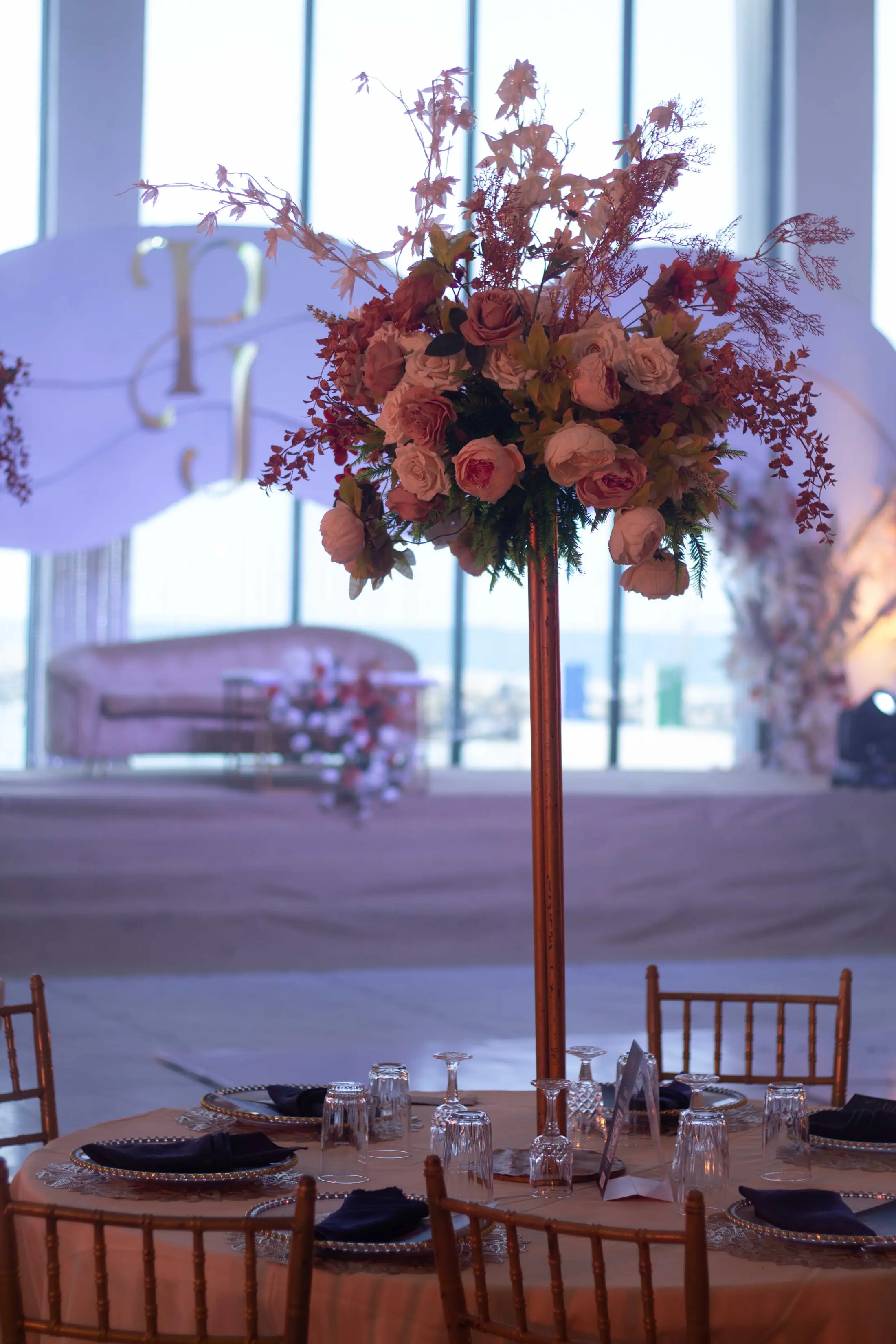 A towering arrangement of blush and white flowers