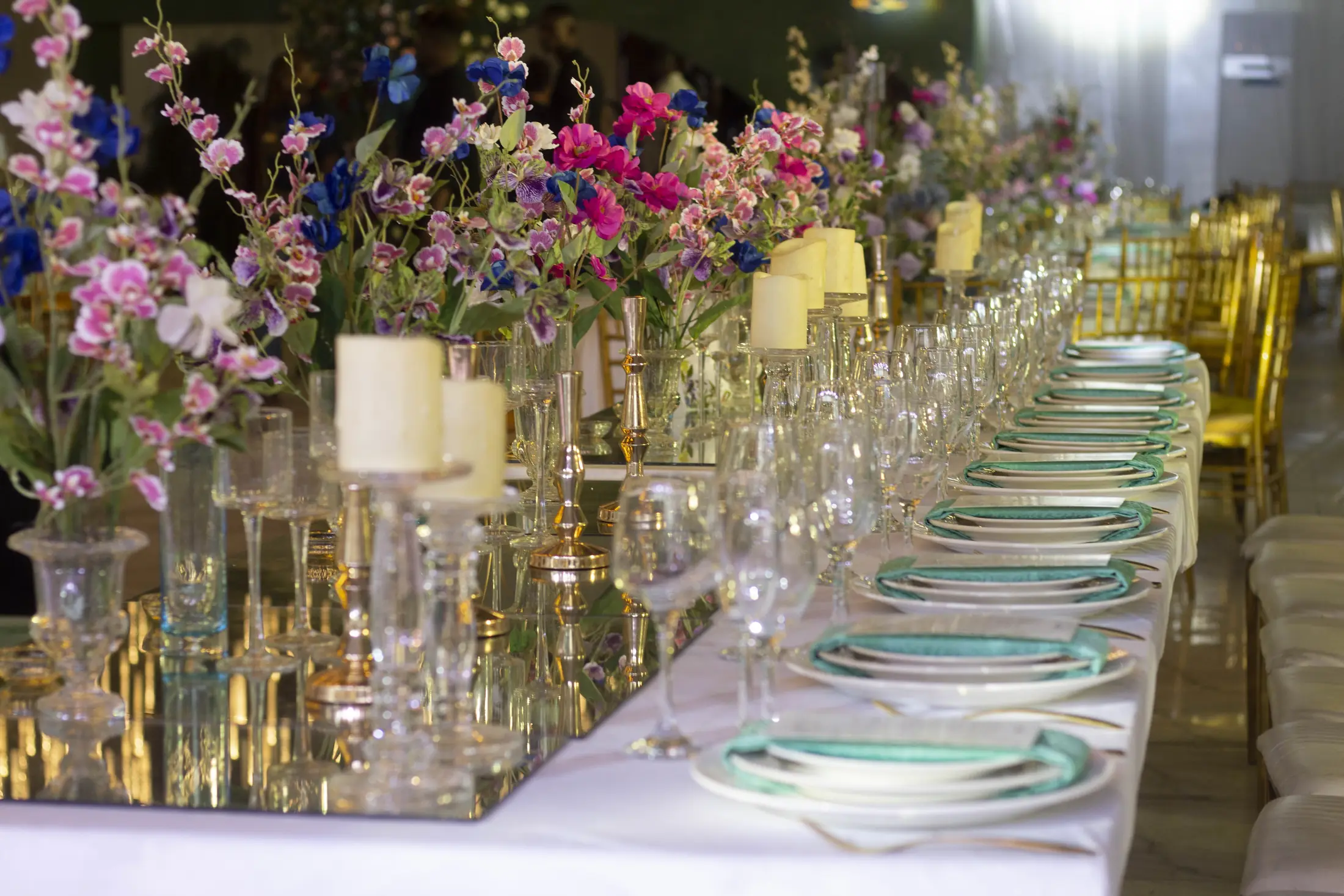 Candles and flowers crowding a reception table