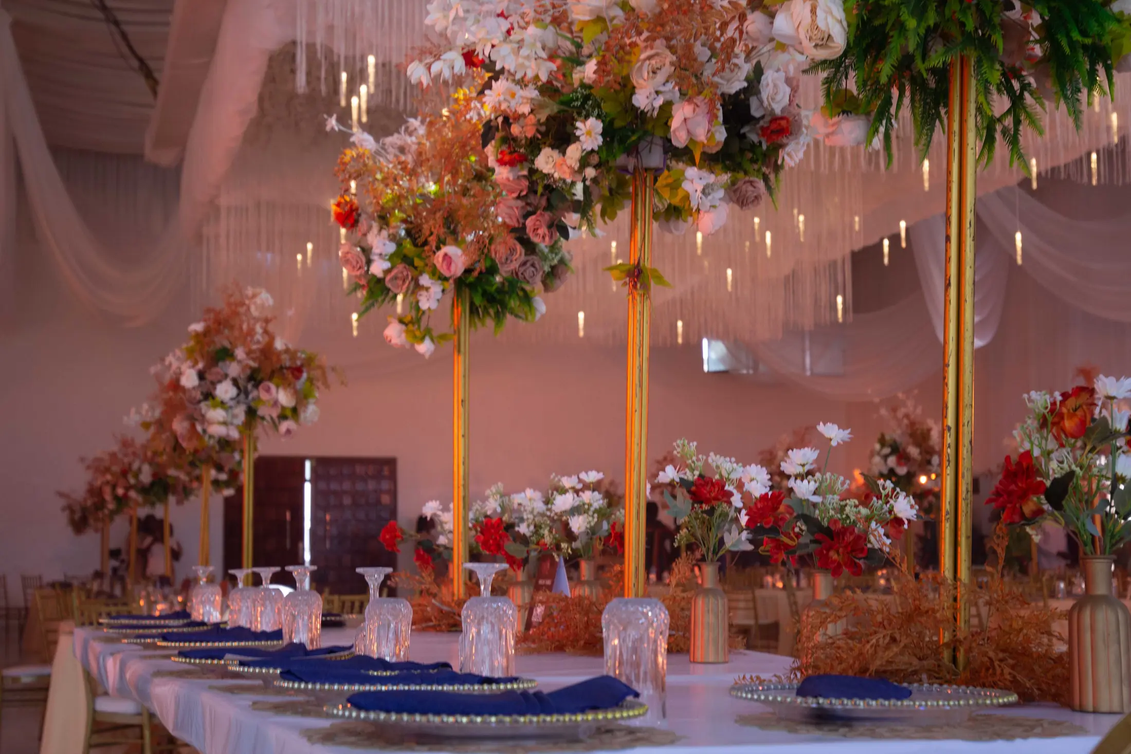 Tall flower centrepieces across the reception